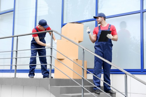 Removal team loading household belongings into a moving van
