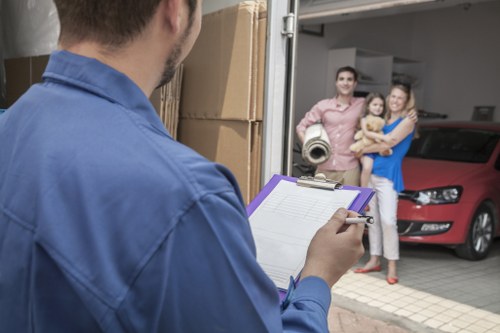 Local movers handling furniture in a residential street in Kentish Town