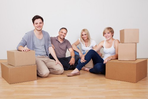 Packed moving boxes and furniture for a van removal service